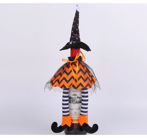 Detail of Halloween witch wine bottle cover with ghost hat and orange mesh skirt