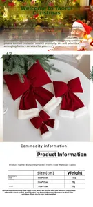 Three sizes of burgundy velvet Christmas bows with white faux fur trim on a white surface