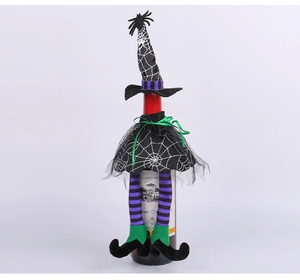 Detail of Halloween witch wine bottle cover with purple mesh skirt and spider web patterns