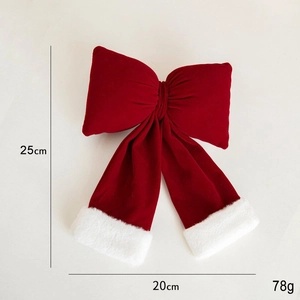 Detail view of large red velvet Christmas bow with measurements 25x20cm and 78g weight