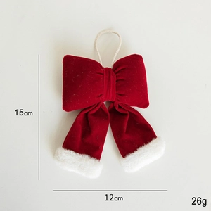 Detail of burgundy velvet Christmas bow with white faux fur trim and hanging cord