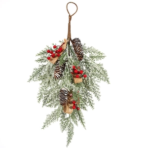 Close-up of frosted Christmas teardrop swag with red berries and natural pine cones