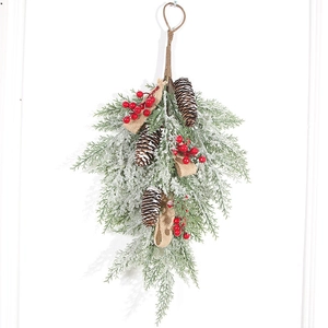 Frosted Christmas pine swag with natural pinecones, red berries, and burlap bow