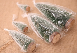 Miniature snow-frosted cedar trees with wooden bases in various sizes for Christmas decor