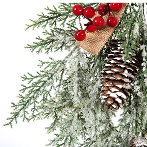Christmas wreath with snowy pine branches, red berries, cones and burlap bow