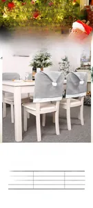 Detail of grey non-woven Christmas chair cover with white pom-pom on white wooden chair
