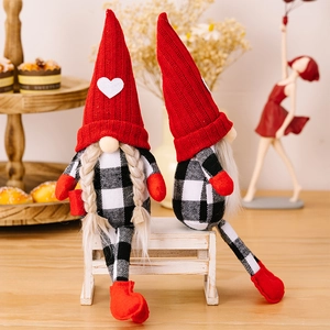 Detail of red knitted hats and heart patches on Swedish gnomes home decorations
