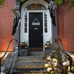 Hanging skeleton ghosts with tattered robes for Halloween porch decoration