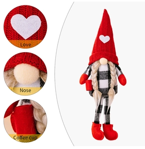 Close-up of red knitted hat with heart and coffee cup detail on Swedish gnome plush