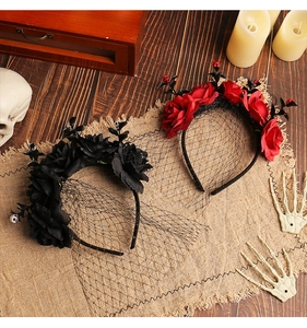 Close-up of Gothic Halloween rose headbands with black veils and skull details on a wooden table