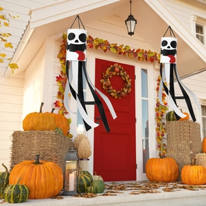 Halloween ghost windsocks set with skull faces hanging on a festive decorated porch