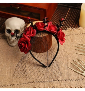 Detail of Halloween rose headband with red skulls and a black mesh veil for gothic party