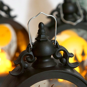 Macro detail of the vintage Halloween lantern top with ornate scrolling and wire handle