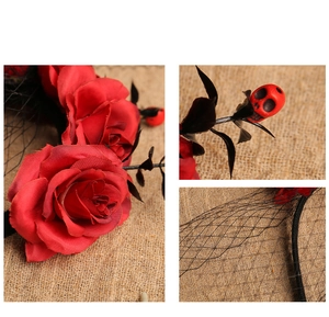 Detail of Gothic Halloween headband with red roses, black mesh veil, and red skull charm
