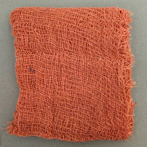 Macro detail of orange mesh fabric for Halloween spooky party decorations and scene layout