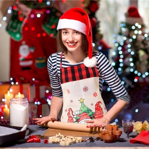 Christmas gnome apron with red buffalo plaid neck strap in cozy kitchen baking scene
