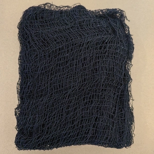 Close-up of Halloween black mesh fabric showing fine texture and uniform netting detail