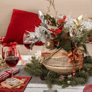 Gros plan d'un ornement de Noël avec branches de pin et base en toile de jute