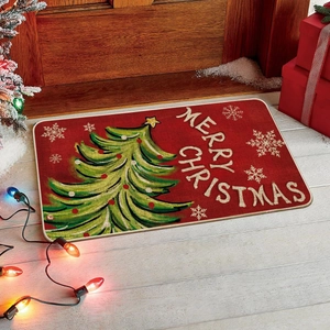 Nahaufnahme der Weihnachtsfußmatte mit Baum und Merry Christmas Text auf rotem Teppich