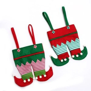 Christmas elf leg gift bags in red and green felt with stripes and pom-poms for party decor