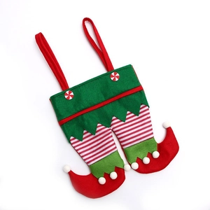 Detail of Christmas elf leg gift bag with felt texture and red white striped patterns