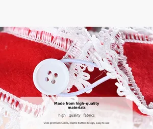 Detail of red Christmas curtain tie with white lace edges and elastic button closure