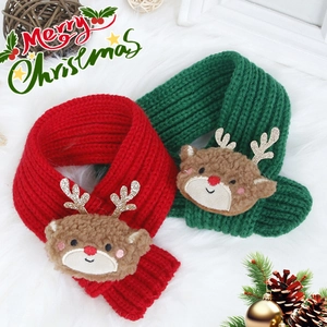 Detail of red and green knitted Christmas pet scarves with plush 3D reindeer decor