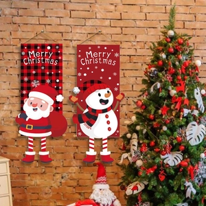 Detail of Santa and Snowman Christmas banners hanging on a festive brick wall background
