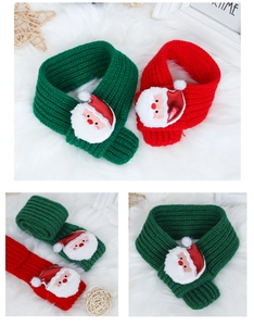 Detail of Christmas pet scarves with Santa Claus embroidery and chunky knit texture