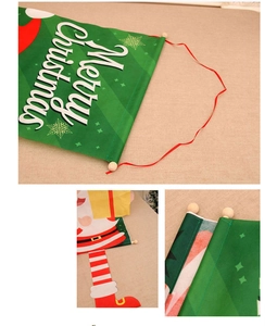 Close-up of green fabric Christmas banner with Merry Christmas text and wooden beads
