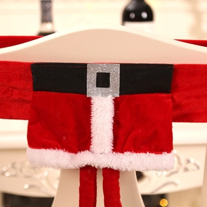 Close-up of Christmas elf chair covers with red felt and black belt buckle details