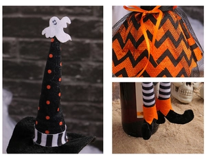 Detail of Halloween witch wine bottle cover with striped legs and orange polka dot hat