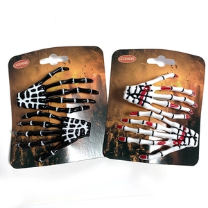Detail of Halloween skeleton bone hair clips in black and white with red blood accents