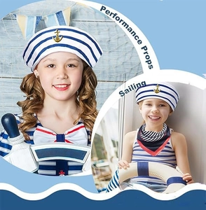 Detail of kids sailor hat with gold anchor badge and nautical theme party accessories