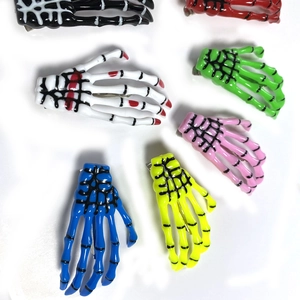 Set of colorful Halloween skull hand bone hair clips in various vibrant gothic shades