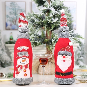 Detail of Christmas wine bottle covers featuring Santa and snowman with knit hat decorations