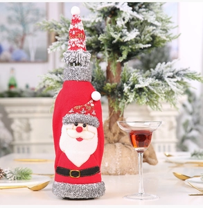 Detailed close-up of Santa Claus wine bottle cover with grey faux fur trim and mini hat