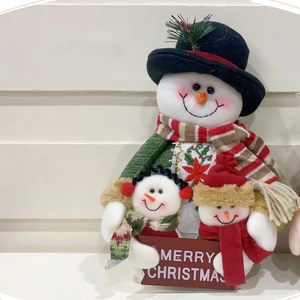 Three plush Christmas snowmen holding a Merry Christmas sign for home holiday decoration