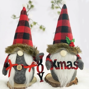 Detail of plush Christmas gnomes with buffalo plaid hats holding JOY and Xmas signs