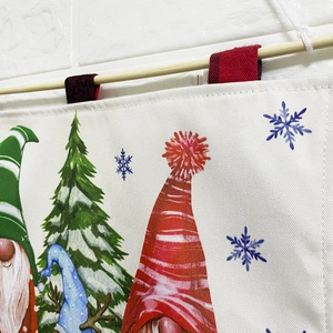 Detail of high-quality canvas Christmas advent calendar with wooden pole on brick wall