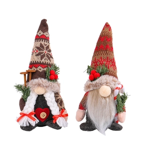 Pair of Christmas gnome plush toys with snowflake knit hats and candy cane decorations