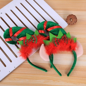Detail of Christmas elf headbands with green pointed hats, red feathers, and elf ears