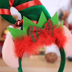 Close-up of a Christmas elf headband with velvet hat, jingle bell and pointed felt ears