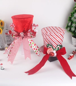 Close-up of velvet Christmas tree topper hats with festive ribbons and peppermint accents