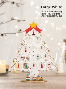 Detail of white wooden Christmas tree desk decor with mini hanging ornaments and train