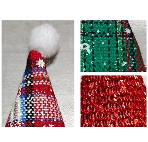 Macro detail of red and green plaid linen mini Christmas hat with white sequins