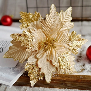 Champagne gold artificial Christmas poinsettia with sequins on wooden tray with snow decoration