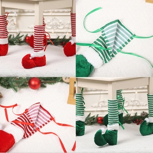 Detail of Christmas elf chair leg covers in red and green stripes with velvet shoes