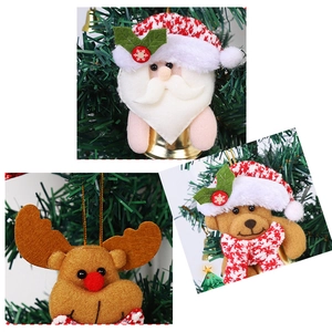 Close-up of Santa, reindeer, and bear plush ornaments hanging on a Christmas tree