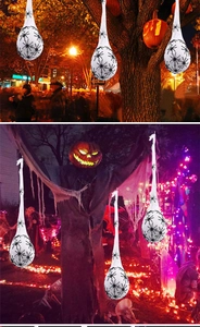 Hanging Halloween spider egg sack decoration with small black spiders on tree branches